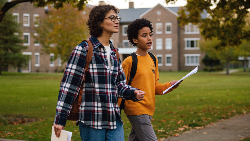 Parent and college-age teen touring a leafy New England university campus in early fall, child support and college costs